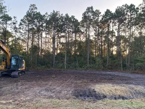 Late-day pass shaping the last of a pad — Coastal Clearing & Debris, Brunswick County NC