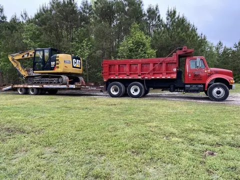 Excavator loaded and chained down for the next job — Coastal Clearing & Debris, Brunswick County NC