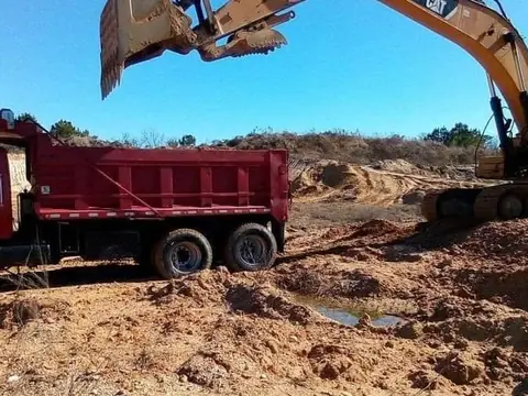 Loading wet spoil straight into the truck — Coastal Clearing & Debris, Brunswick County NC