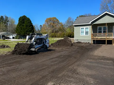 Yard reworked and pitched away from the slab — Coastal Clearing & Debris, Brunswick County NC
